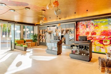 a room with a large window and a large wall with shelves and lamps