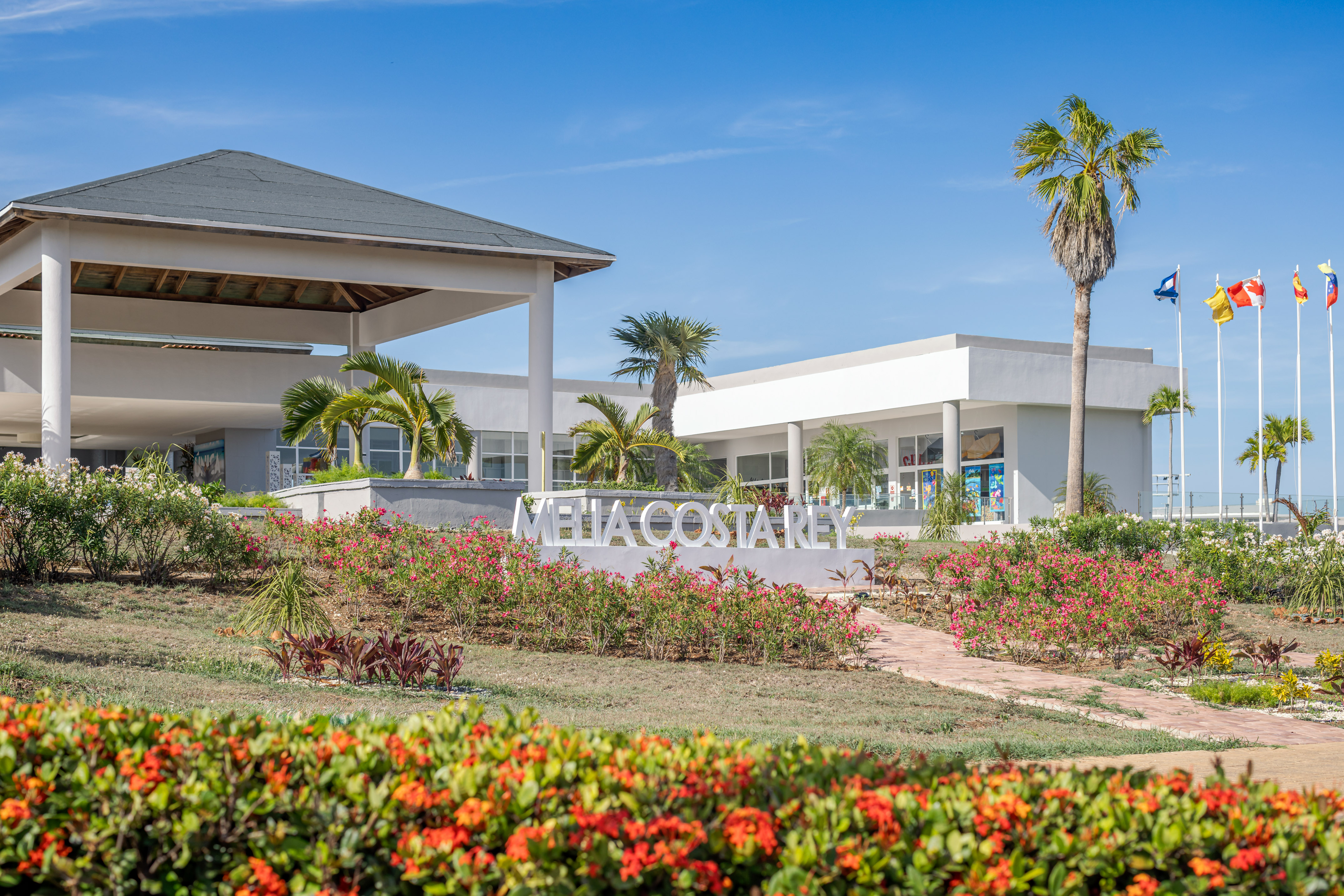 a building with a sign and flowers