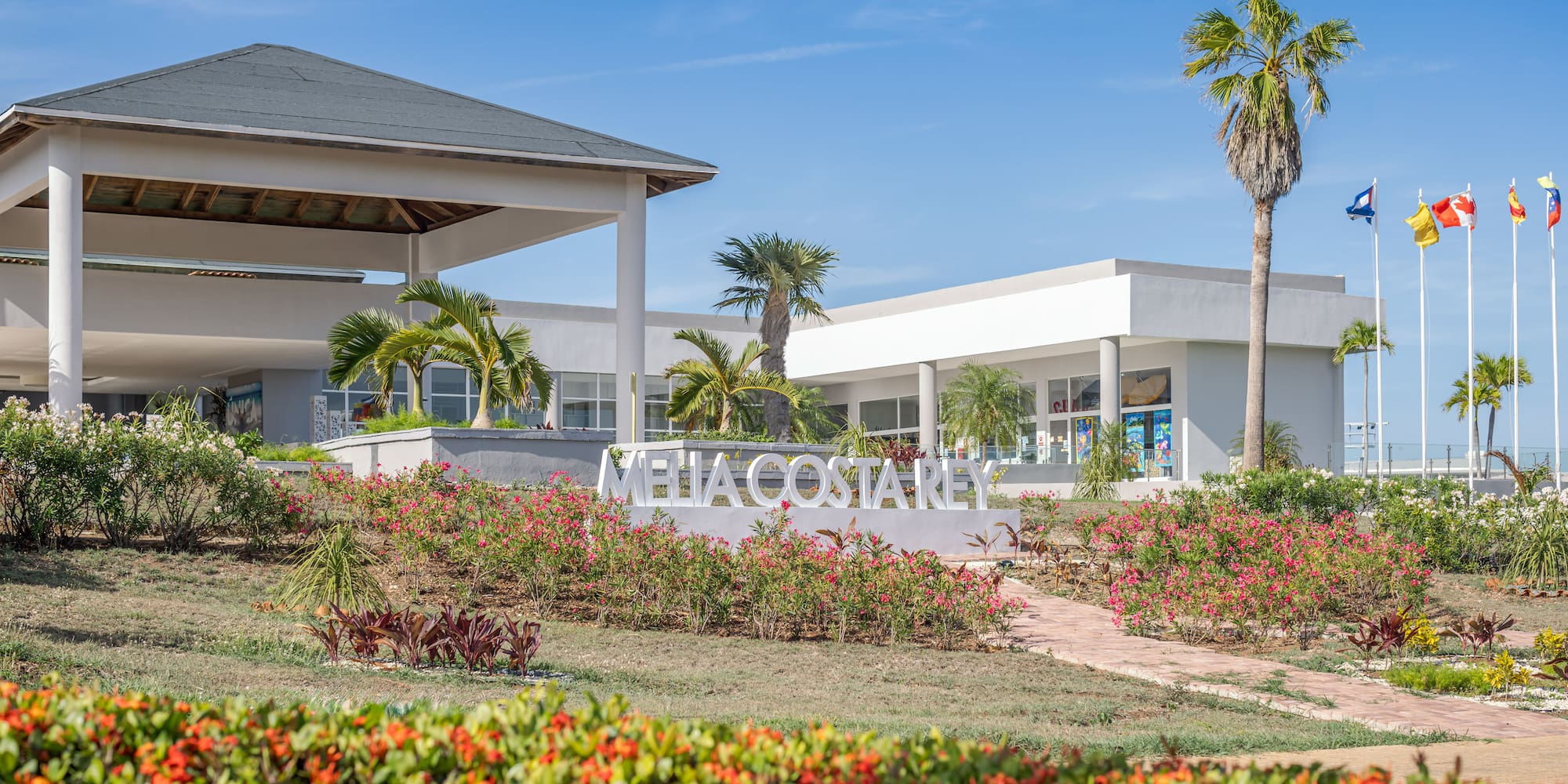 a building with a sign and flowers