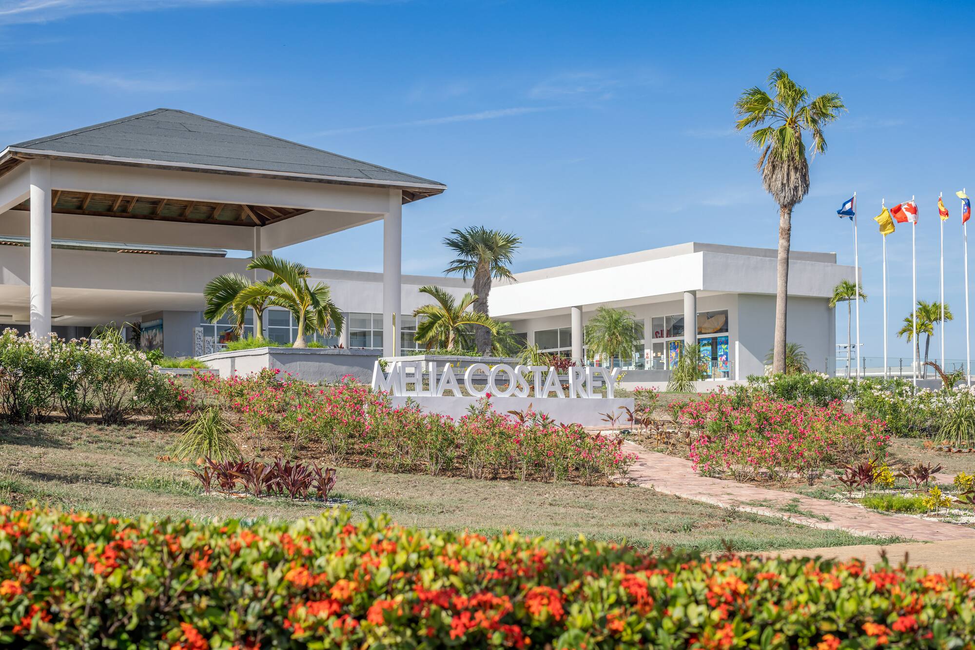 a building with a sign and flowers