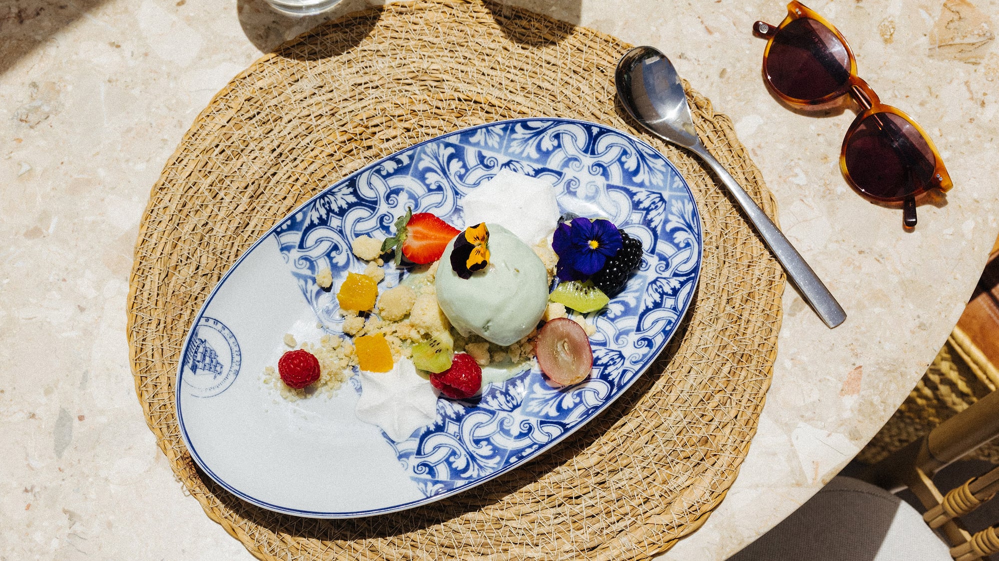 a plate of fruit and ice cream on a table
