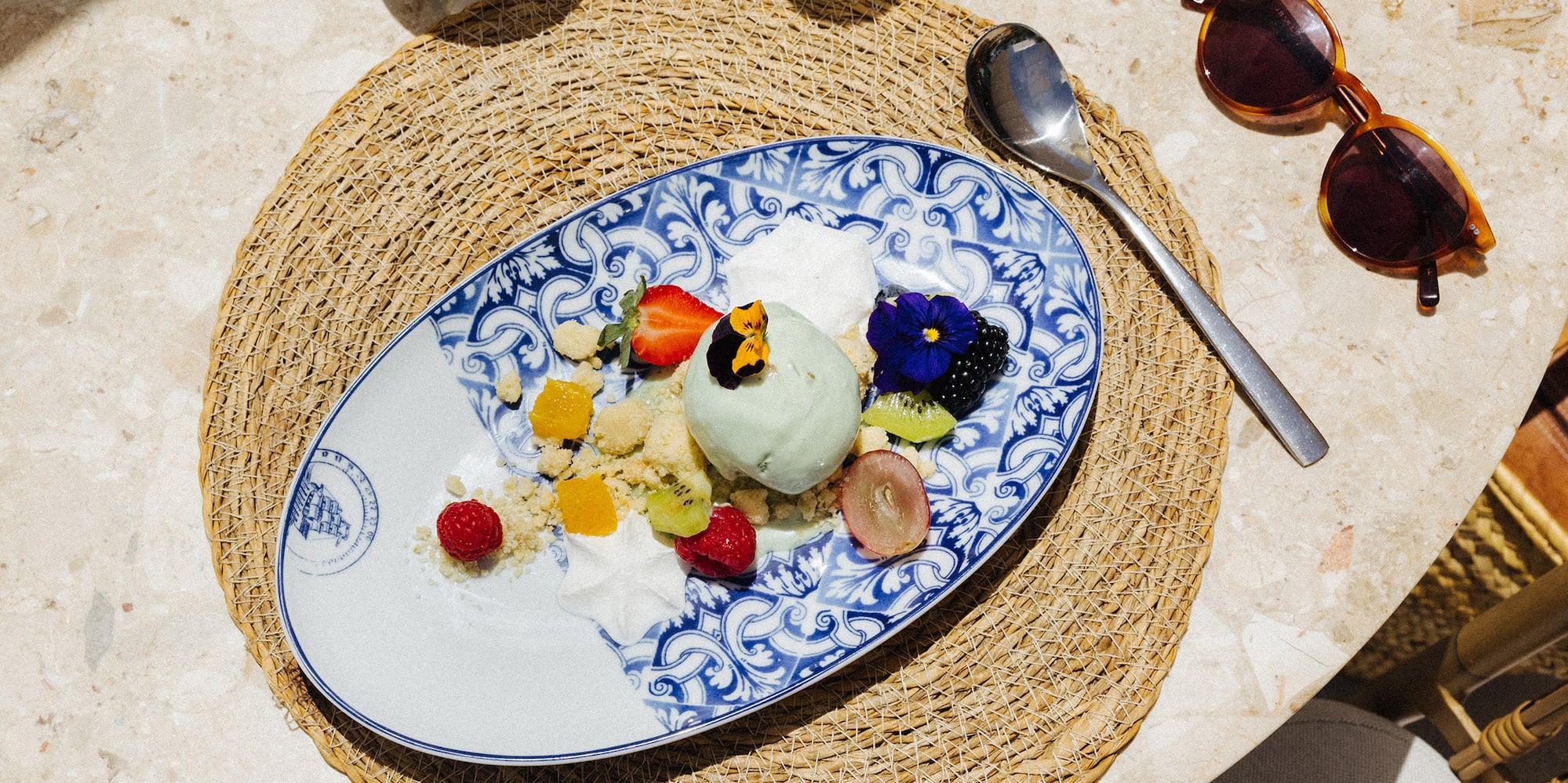 a plate of fruit and ice cream on a table