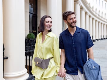 a man and woman holding hands and smiling