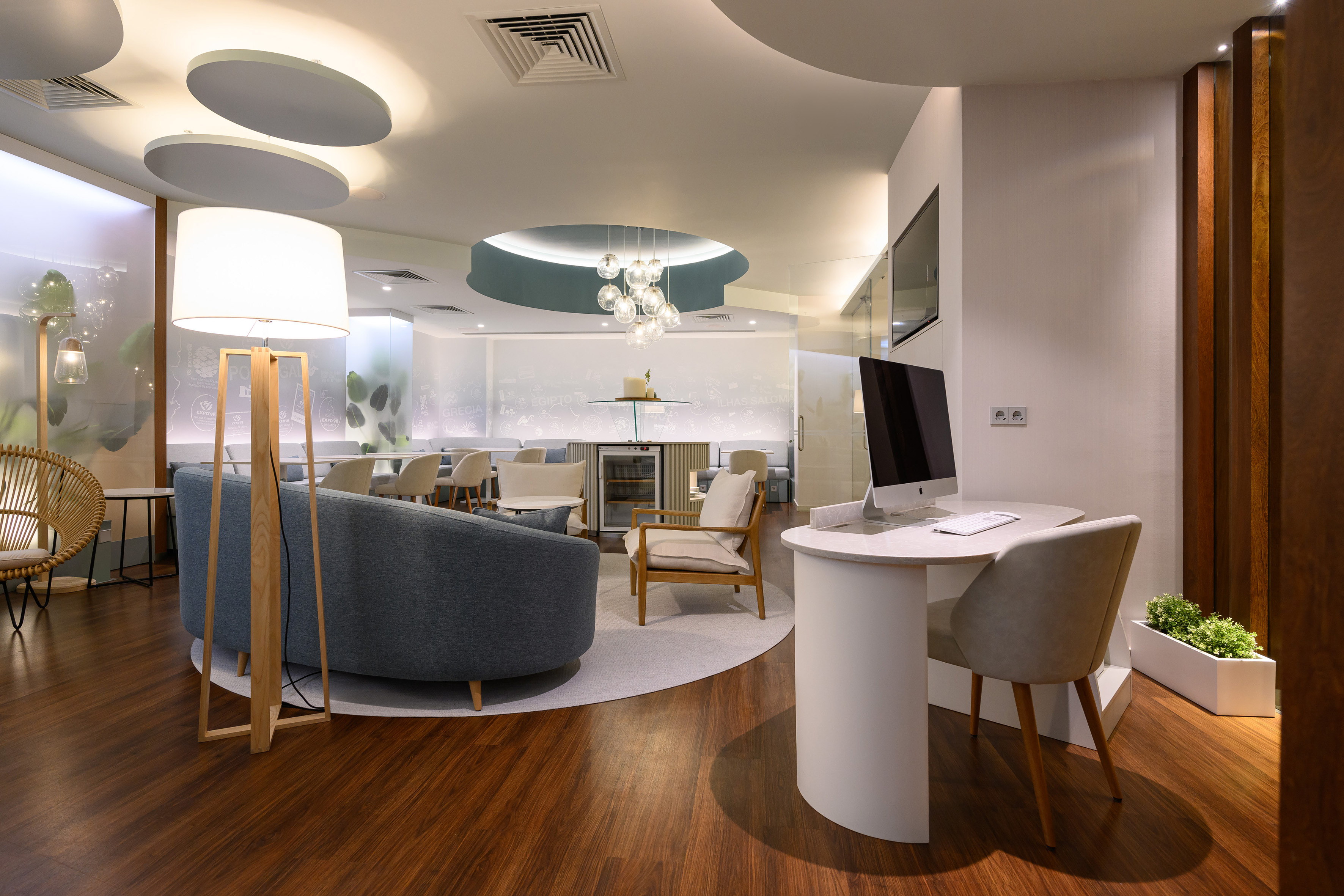 Contemporary lobby lounge with diverse seating, work desk, and modern lighting.
