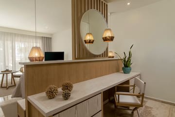 a room with a mirror and a table and chair