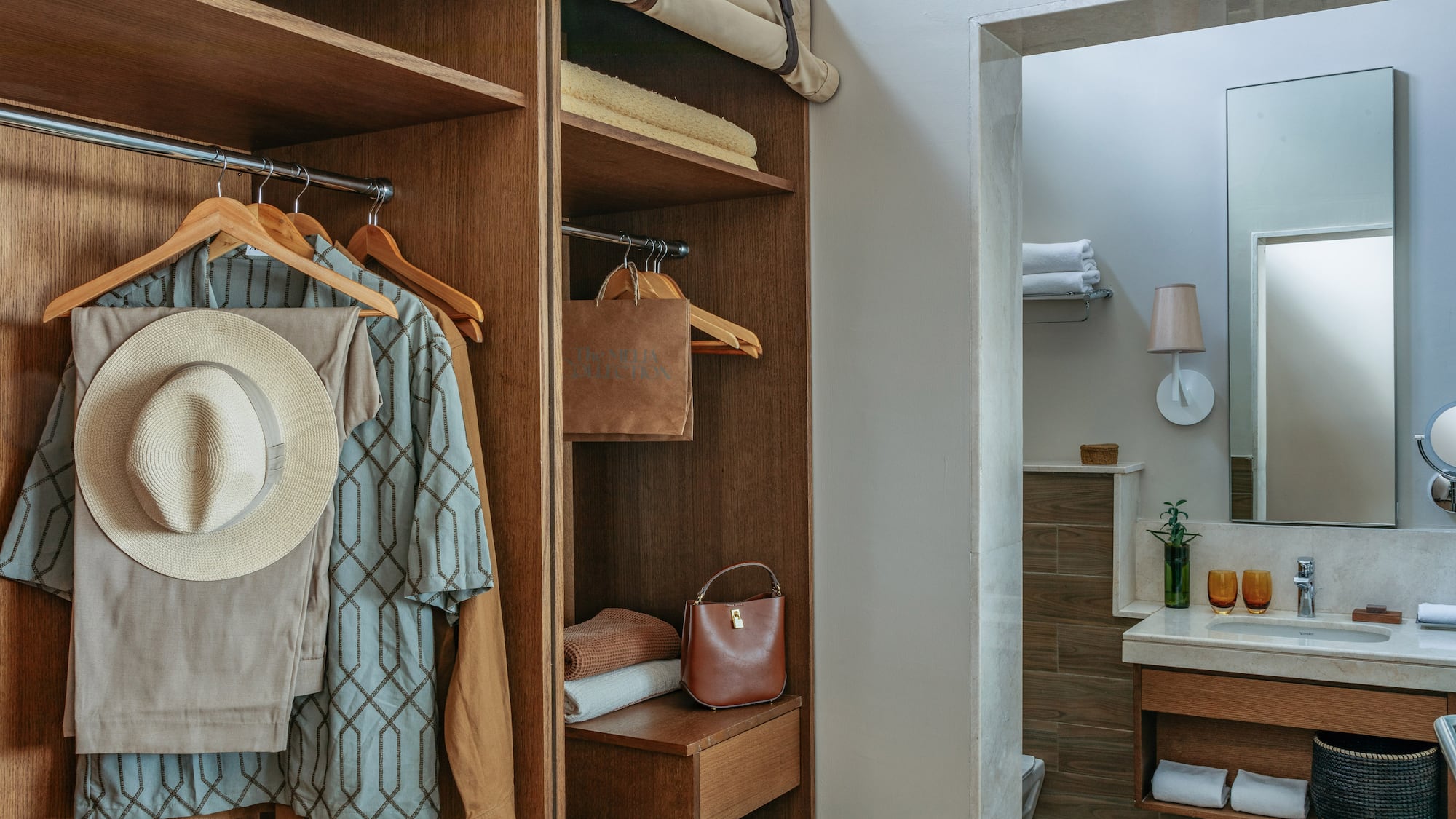 Wood wardrobe with resort wear and contemporary bathroom vanity area.