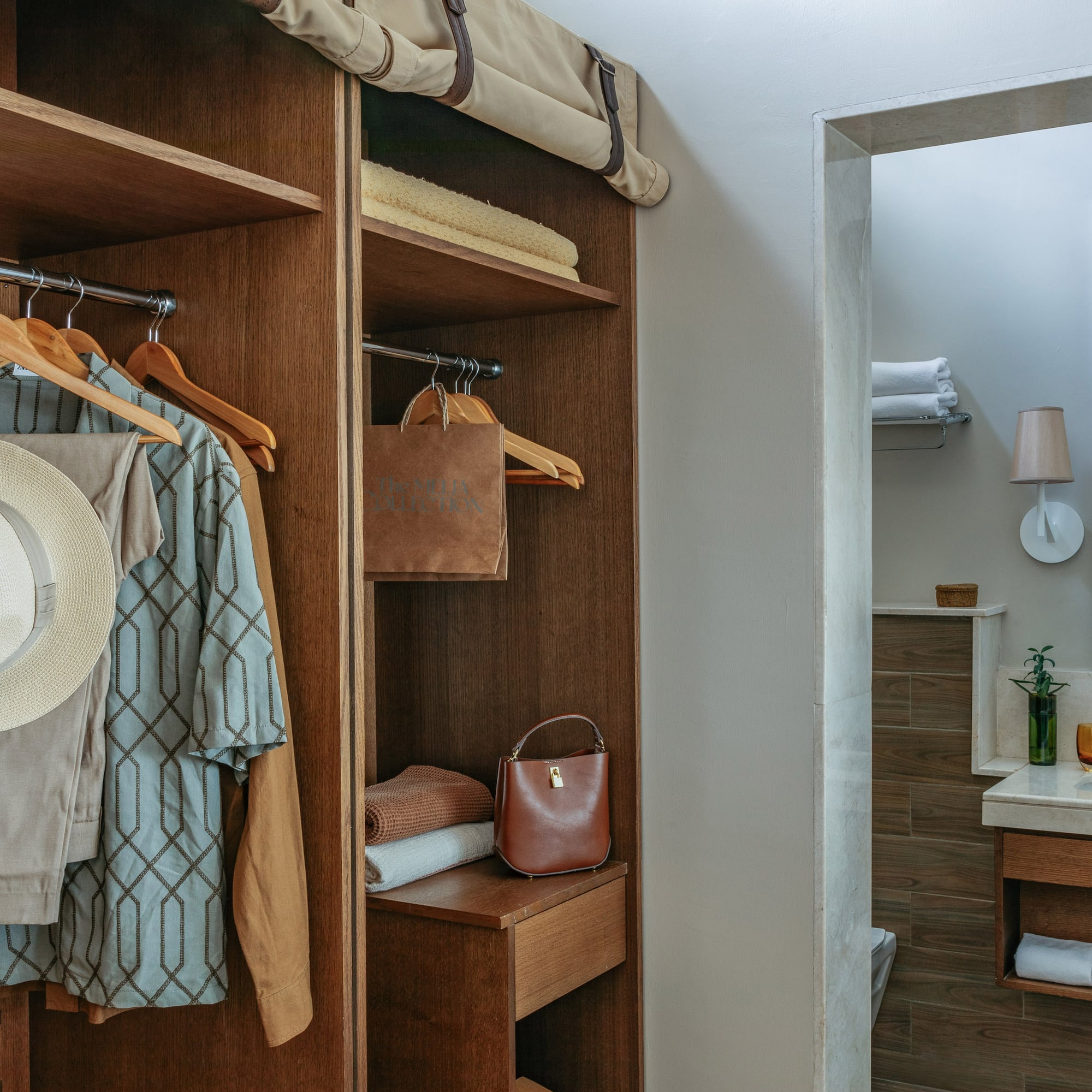 Wood wardrobe with resort wear and contemporary bathroom vanity area.
