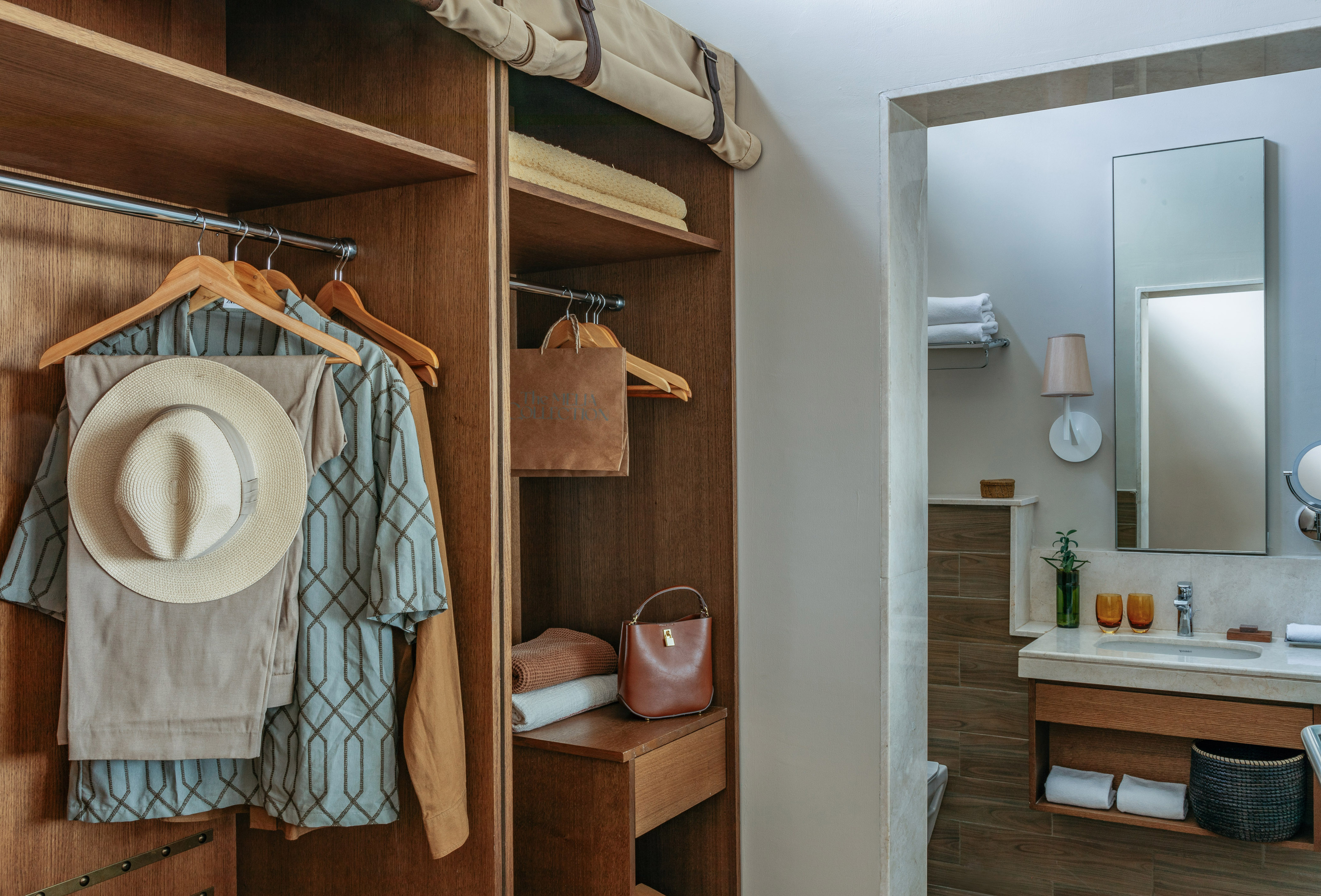 Wood wardrobe with resort wear and contemporary bathroom vanity area.
