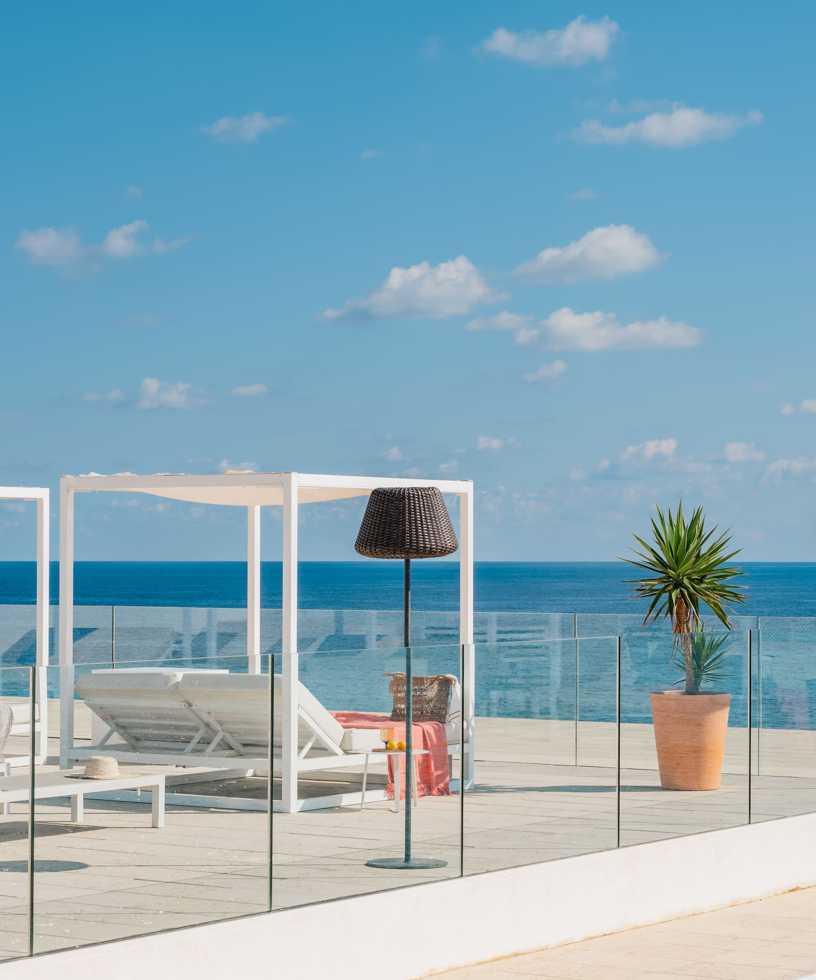 a deck with chairs and umbrellas on a sunny day