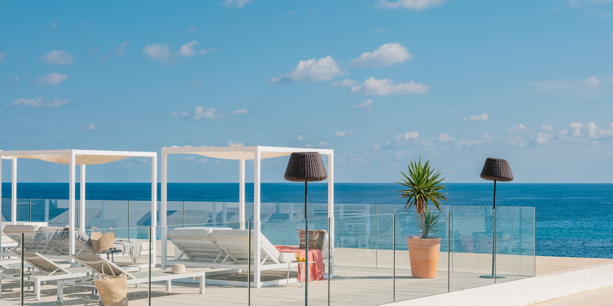 a deck with chairs and umbrellas on a sunny day