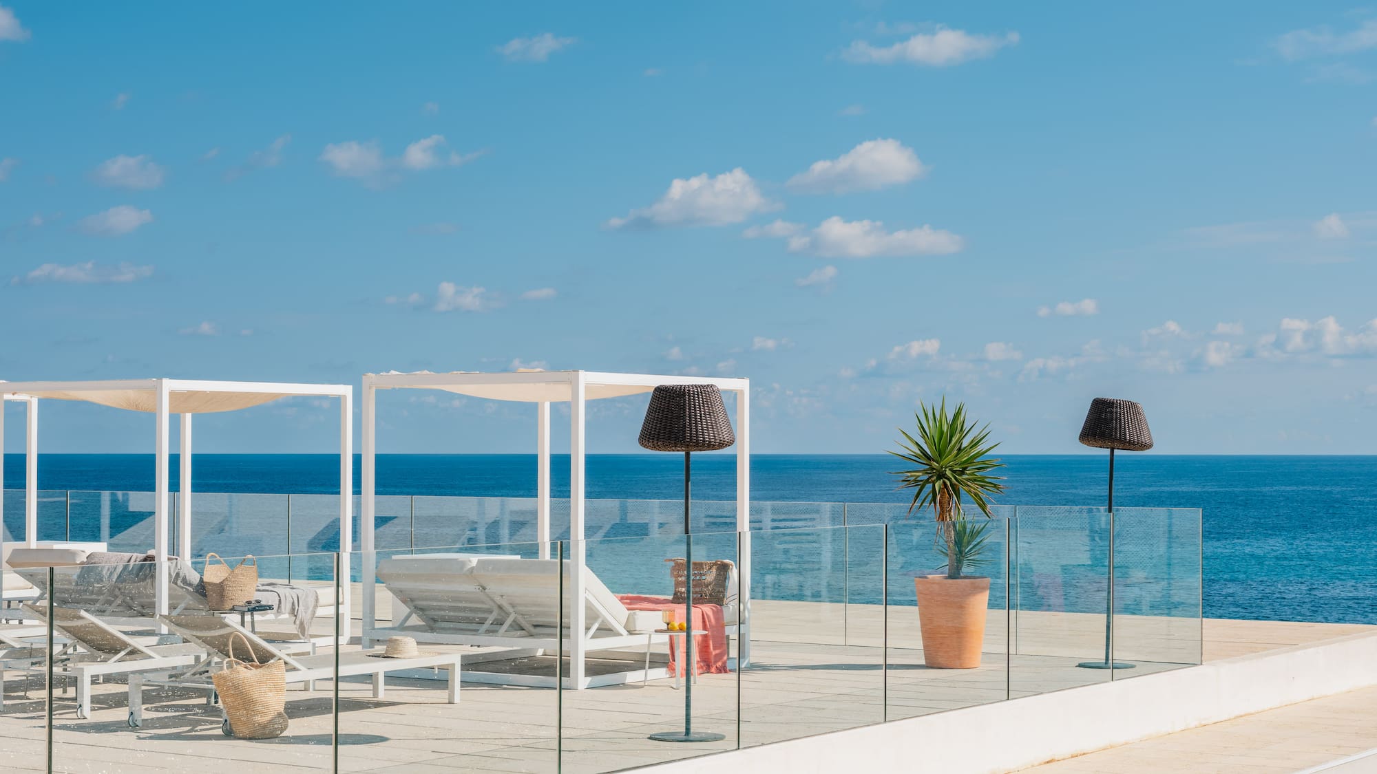 a deck with chairs and umbrellas on a sunny day