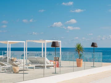 a deck with chairs and umbrellas on a sunny day