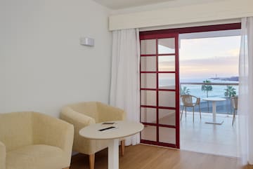 a room with a table and chairs and a glass door