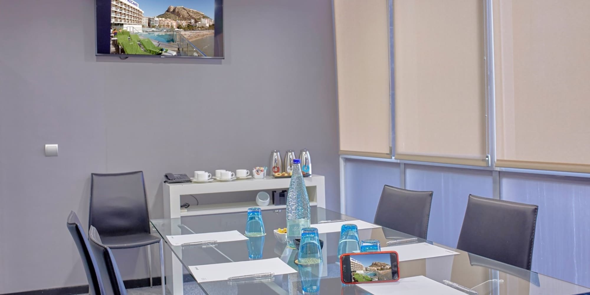 a glass table with a glass top and chairs around it