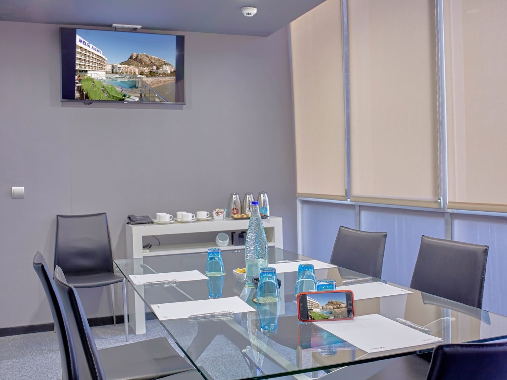 a glass table with a glass top and chairs around it