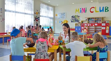 um grupo de crianças sentadas às mesas na sala de aula
