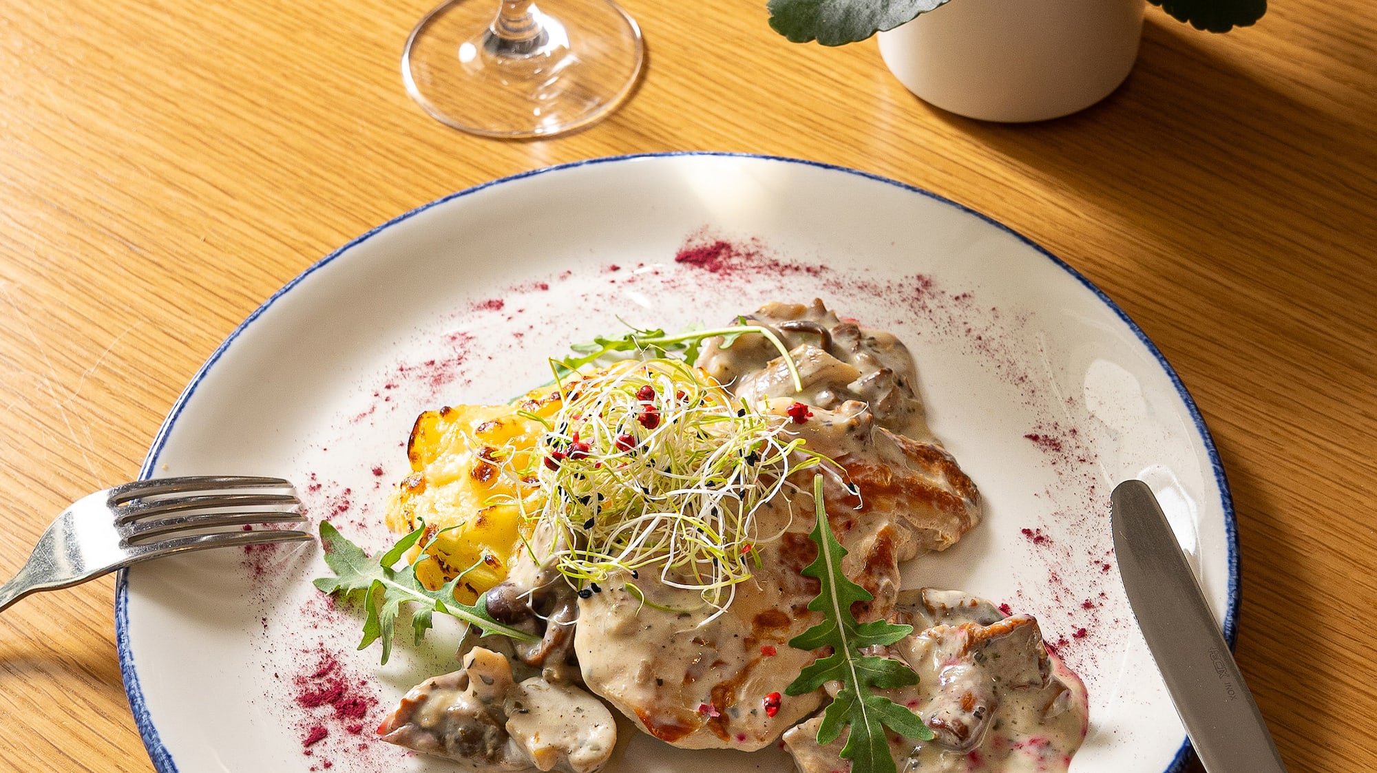 a plate of food and a glass of wine