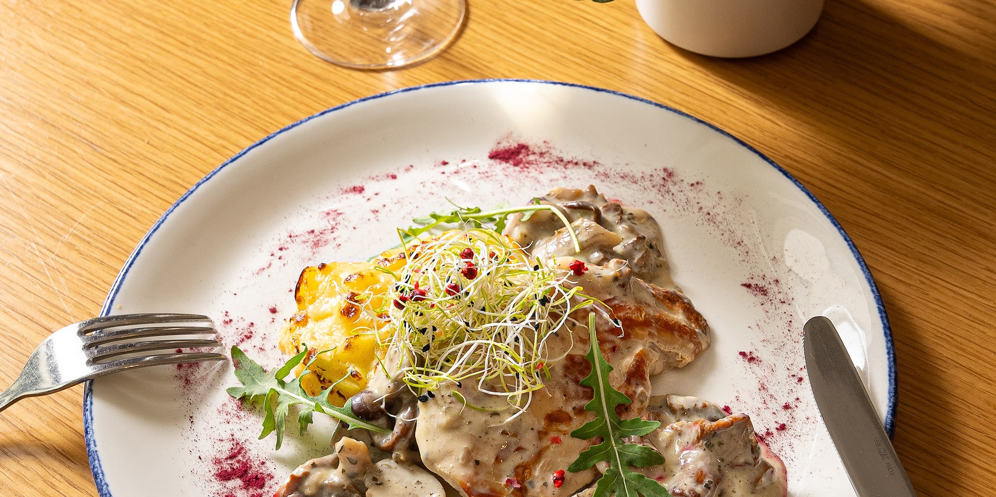 a plate of food and a glass of wine