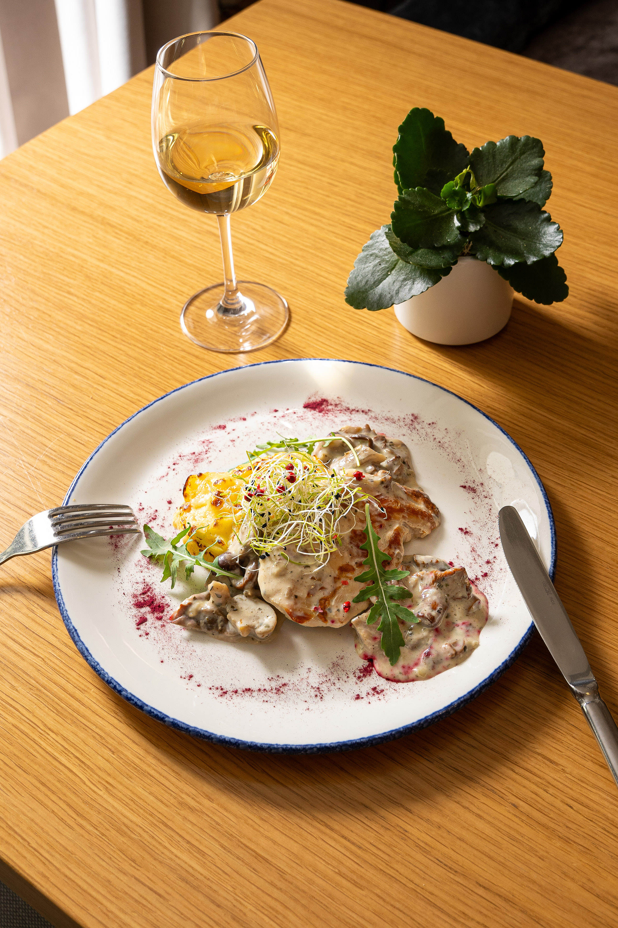 Chicken in creamy mushroom sauce, baked potatoes, microgreens, and white wine.