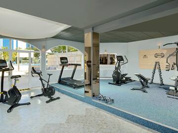 a room with exercise machines and a mirror