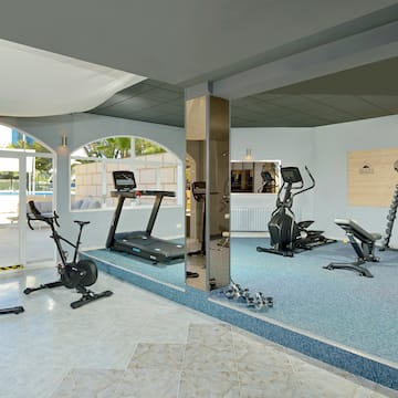 a room with exercise machines and a mirror