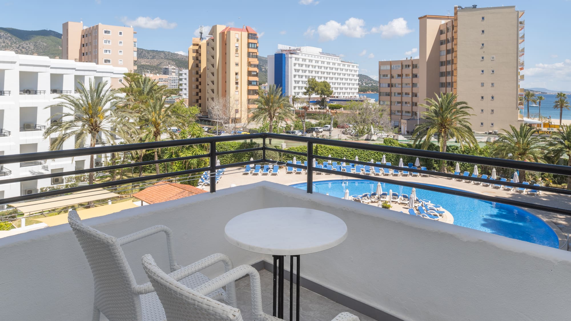 a balcony with a pool and chairs