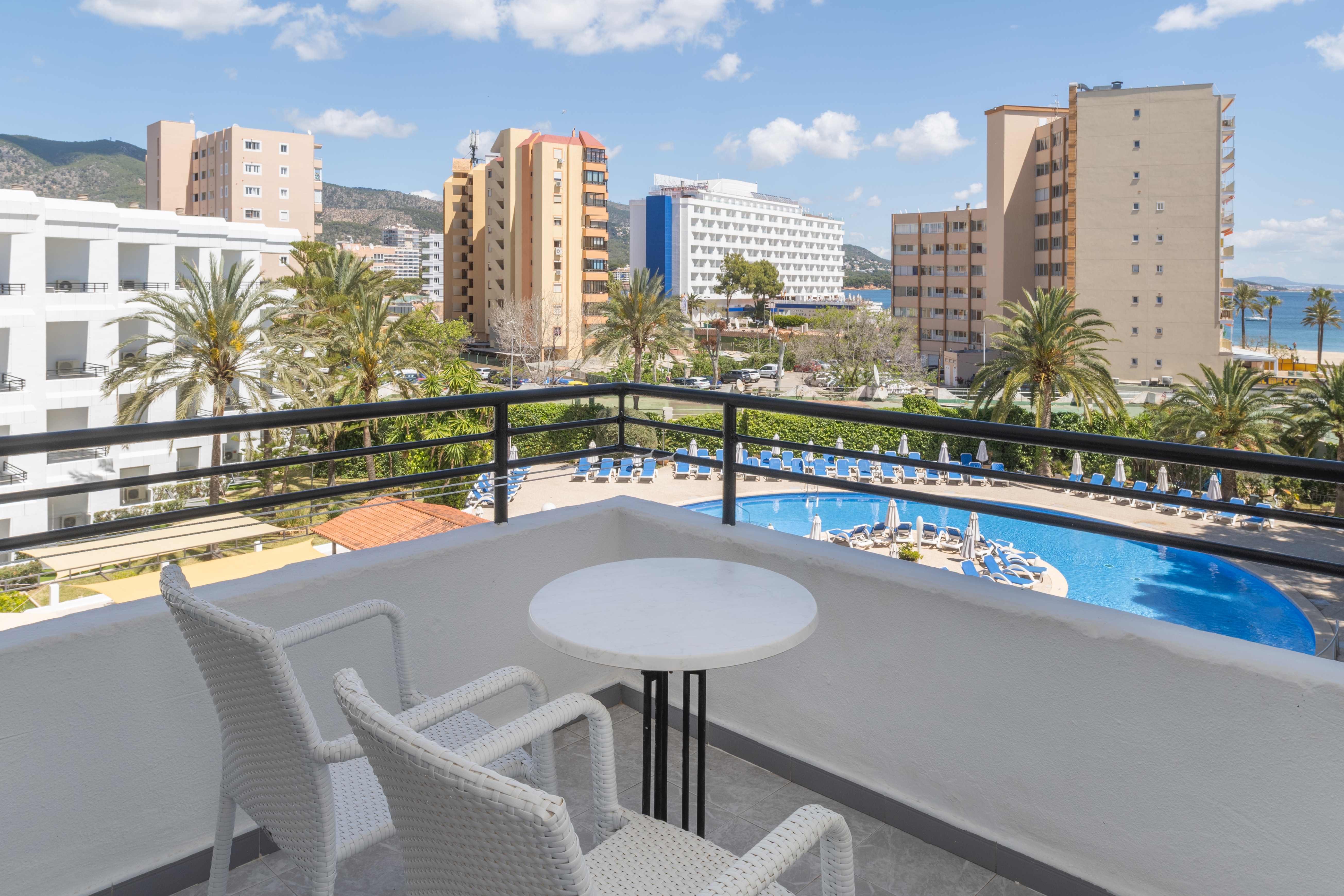 a balcony with a pool and chairs