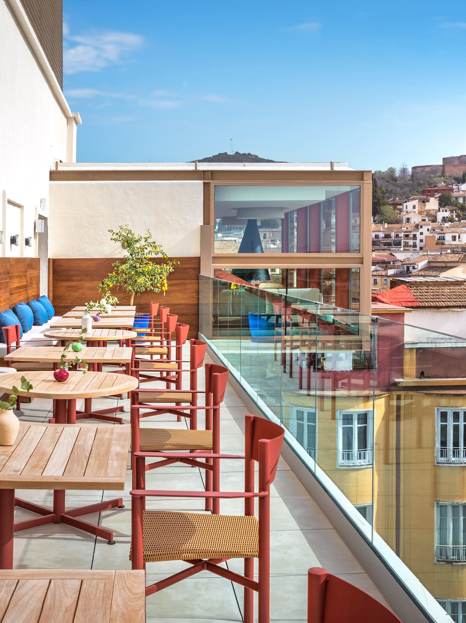 a table and chairs on a balcony with a city in the background