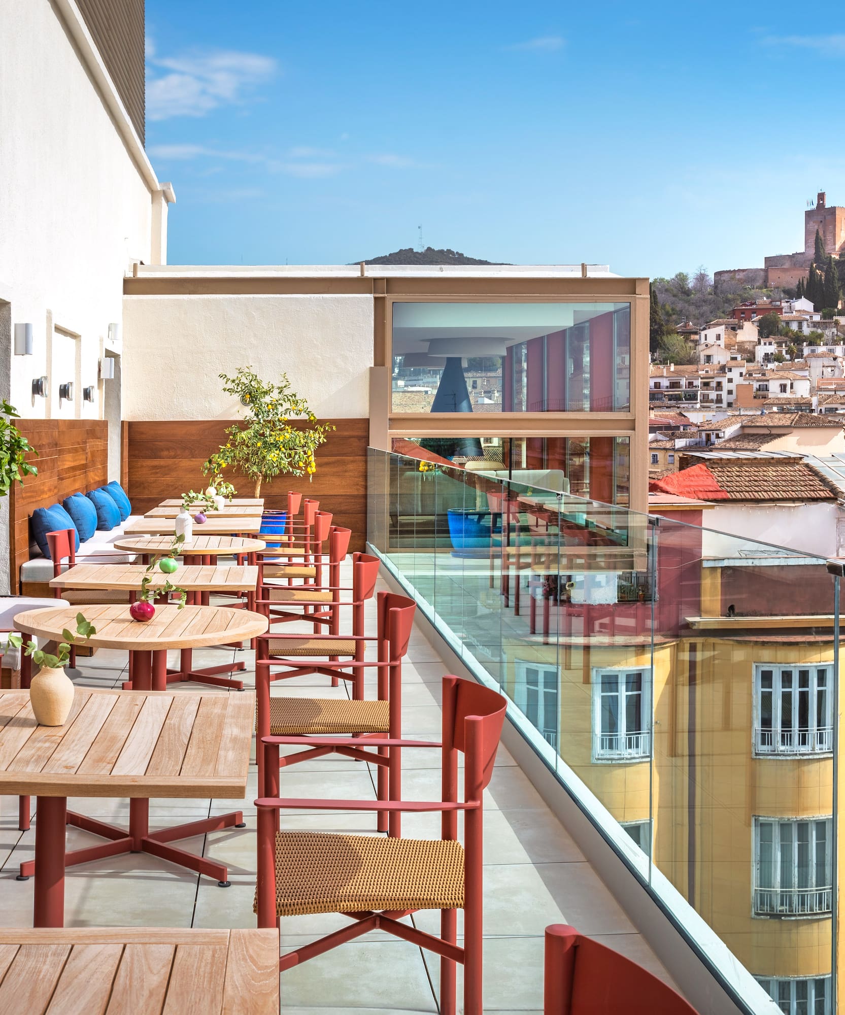 a table and chairs on a balcony with a city in the background
