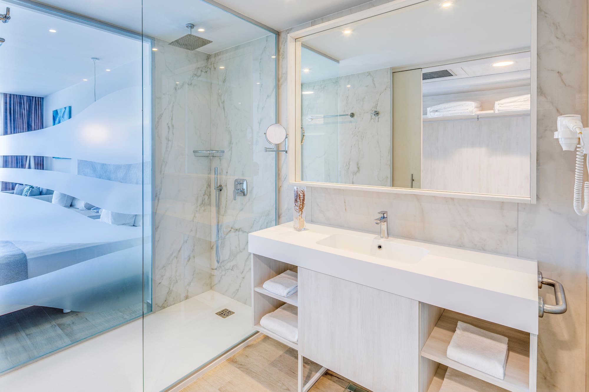 a bathroom with a glass shower and a sink