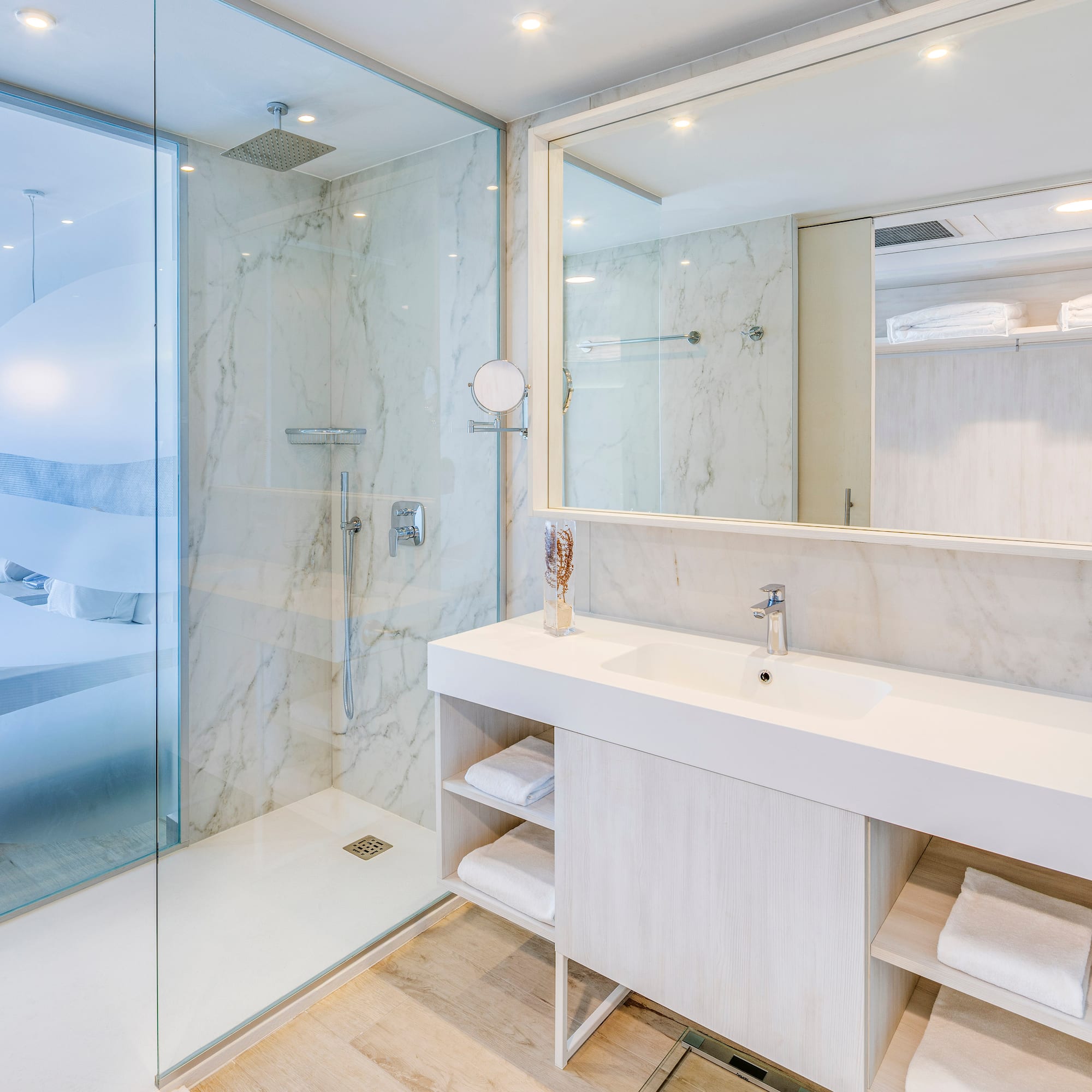 a bathroom with a glass shower and a sink