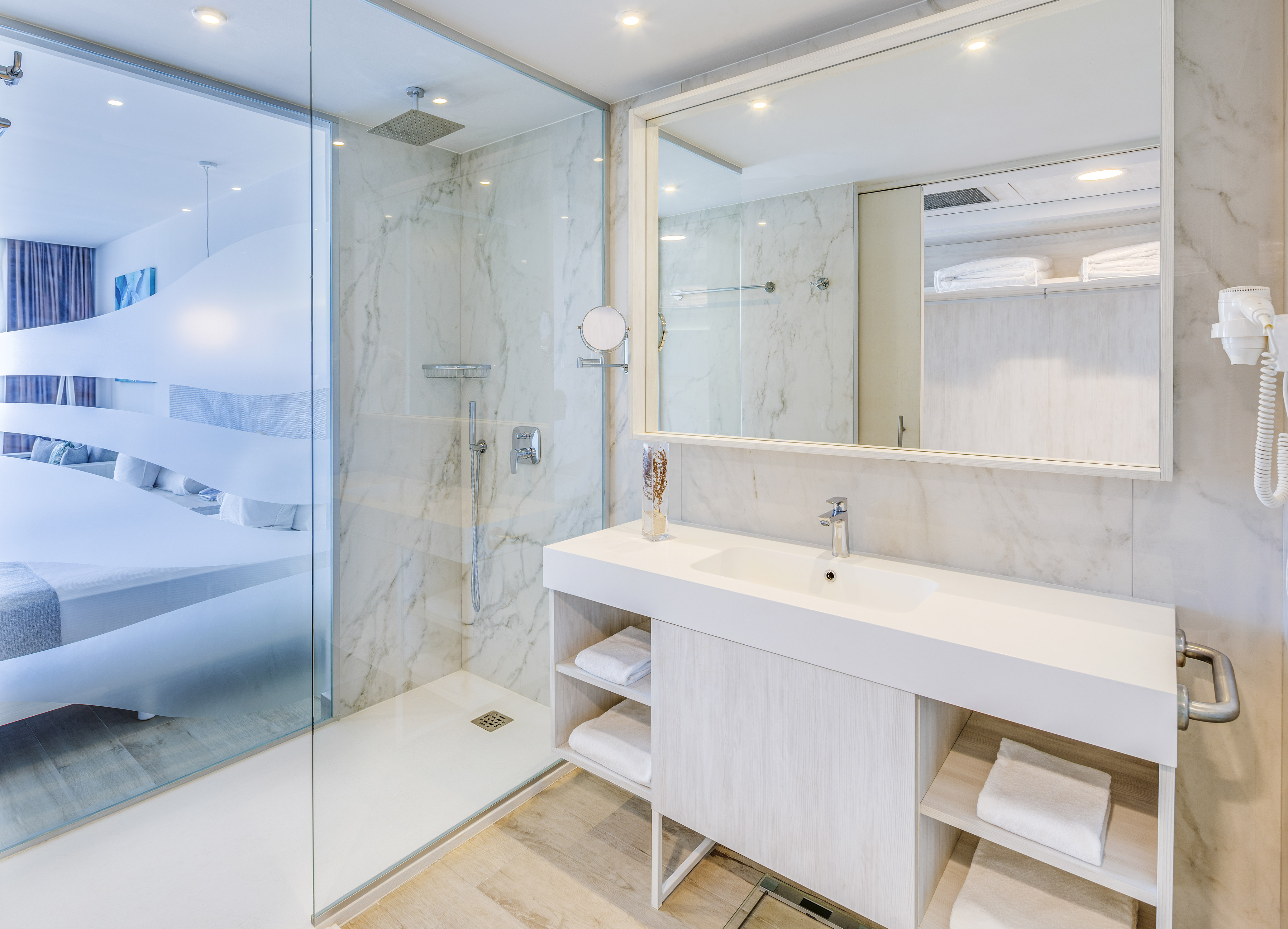a bathroom with a glass shower and a sink