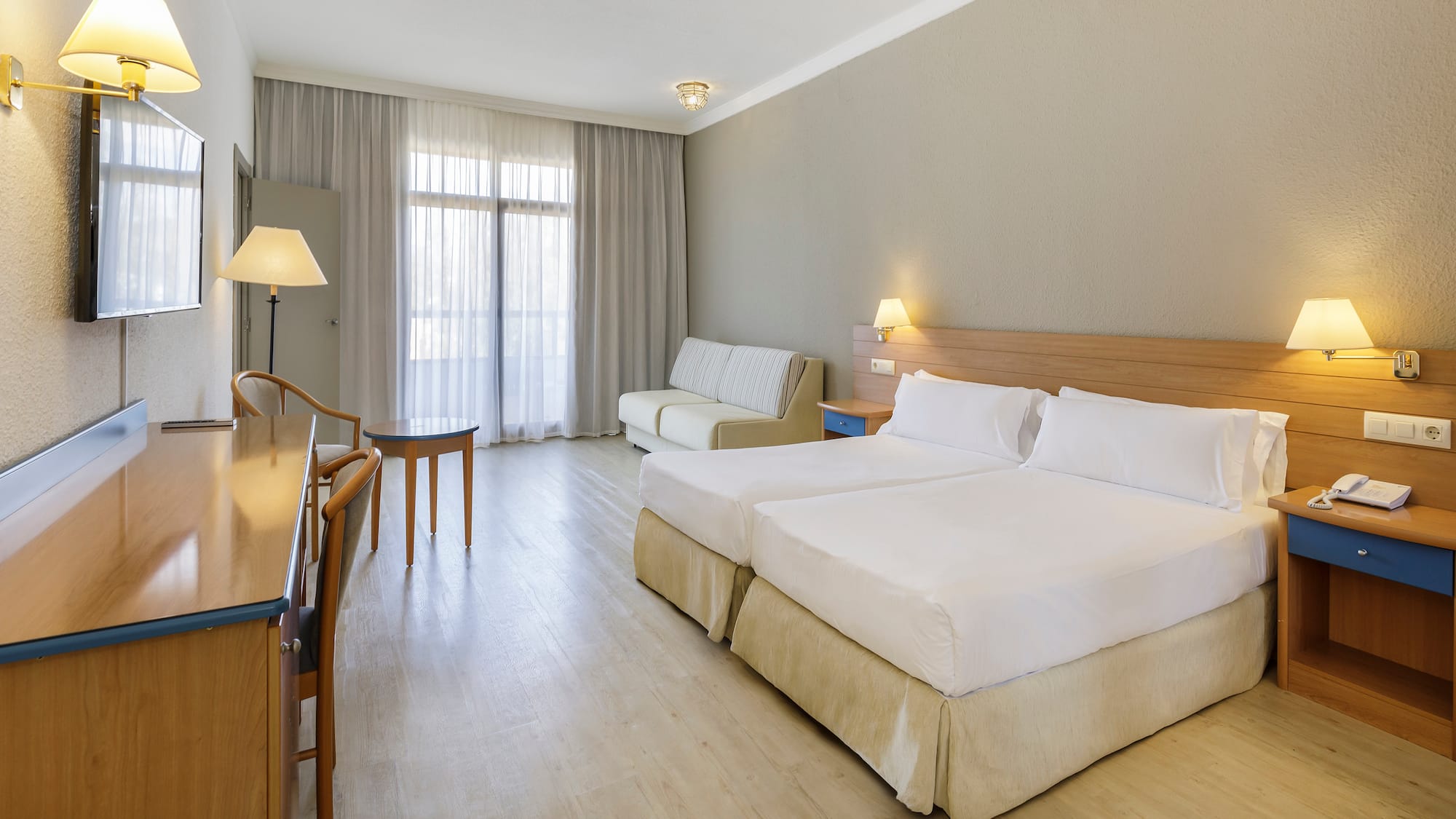 a room with two beds and a table