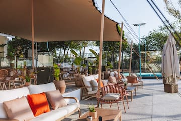 a patio with chairs and tables and a pool
