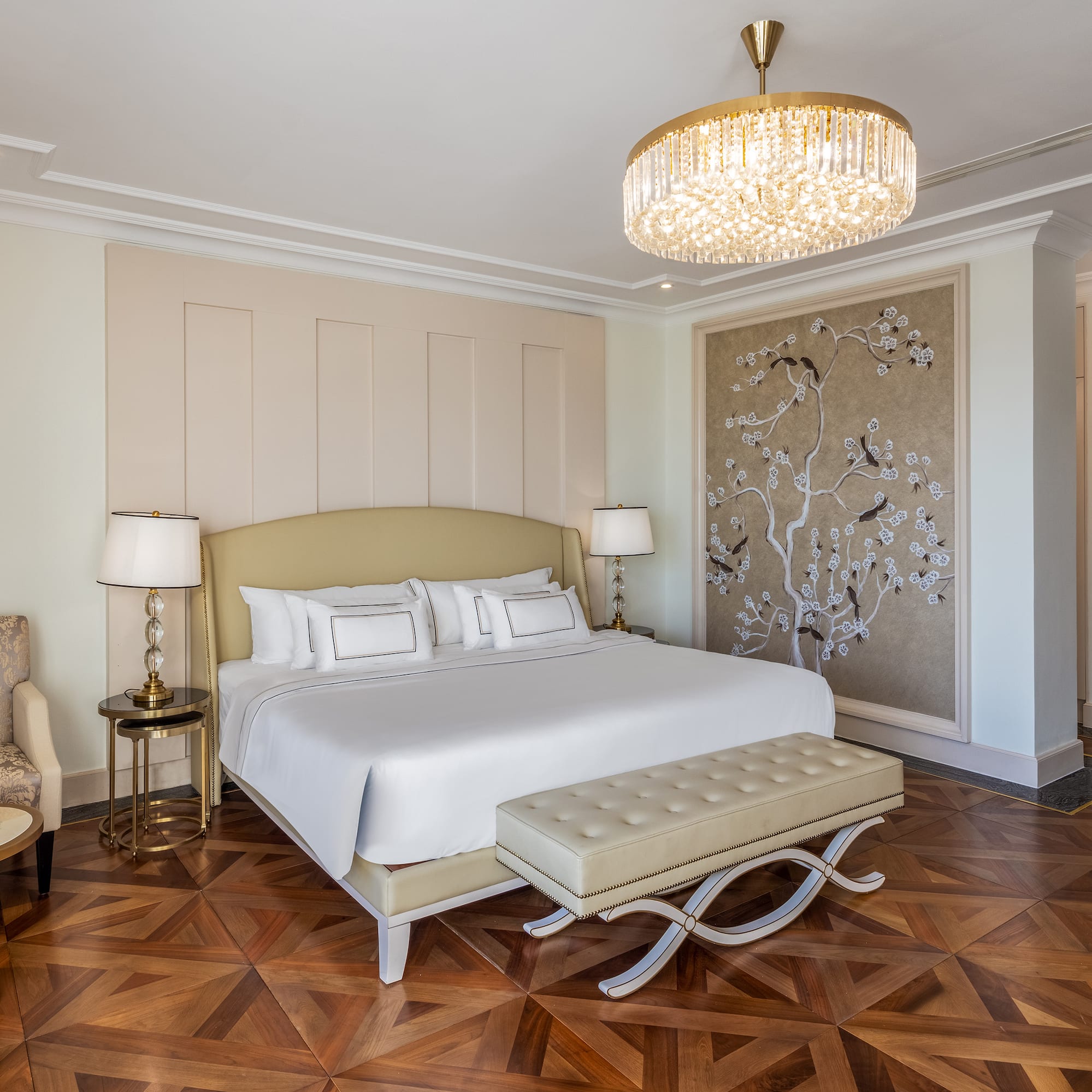 a bedroom with a bed and a chandelier