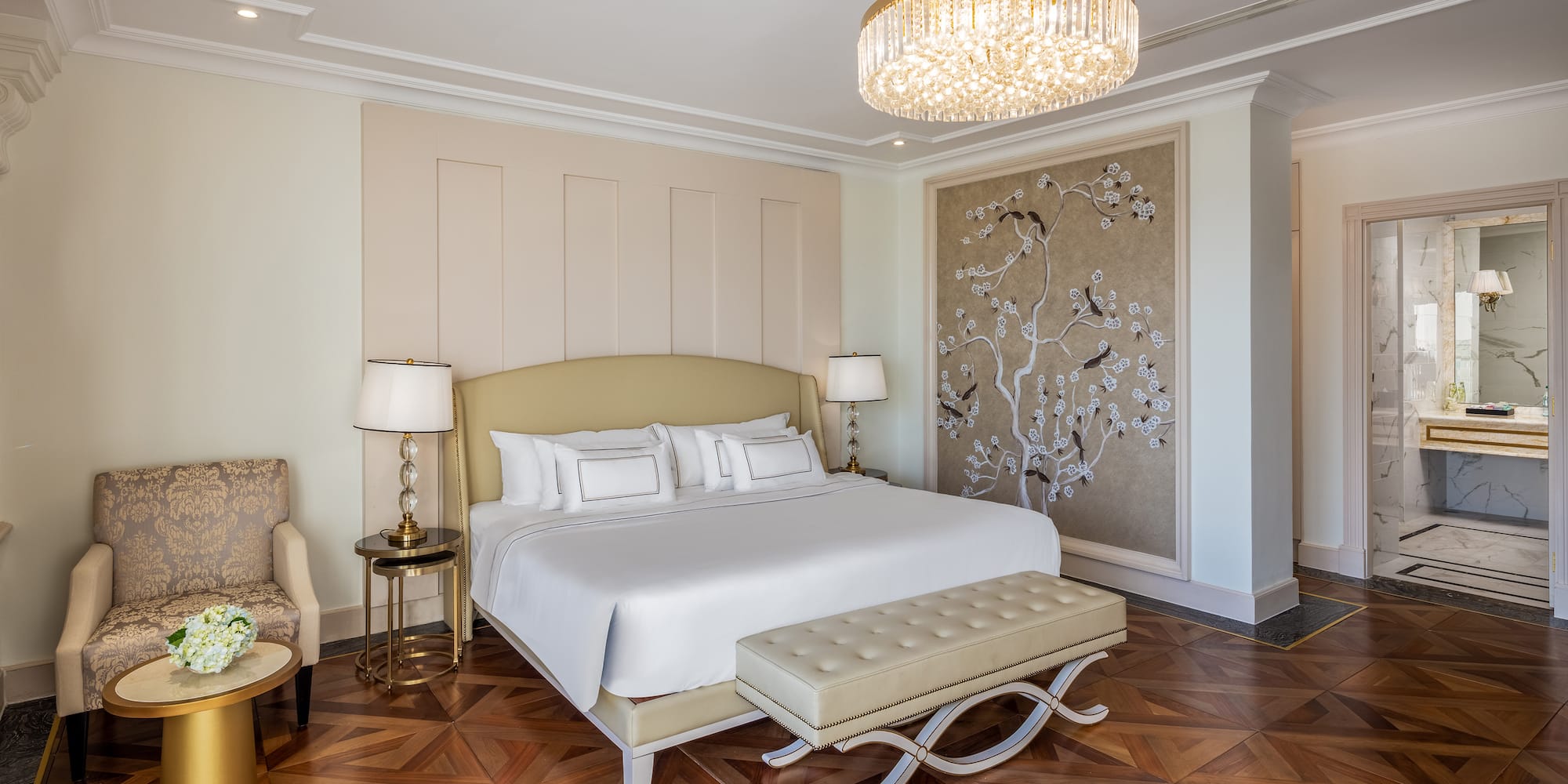 a bedroom with a bed and a chandelier