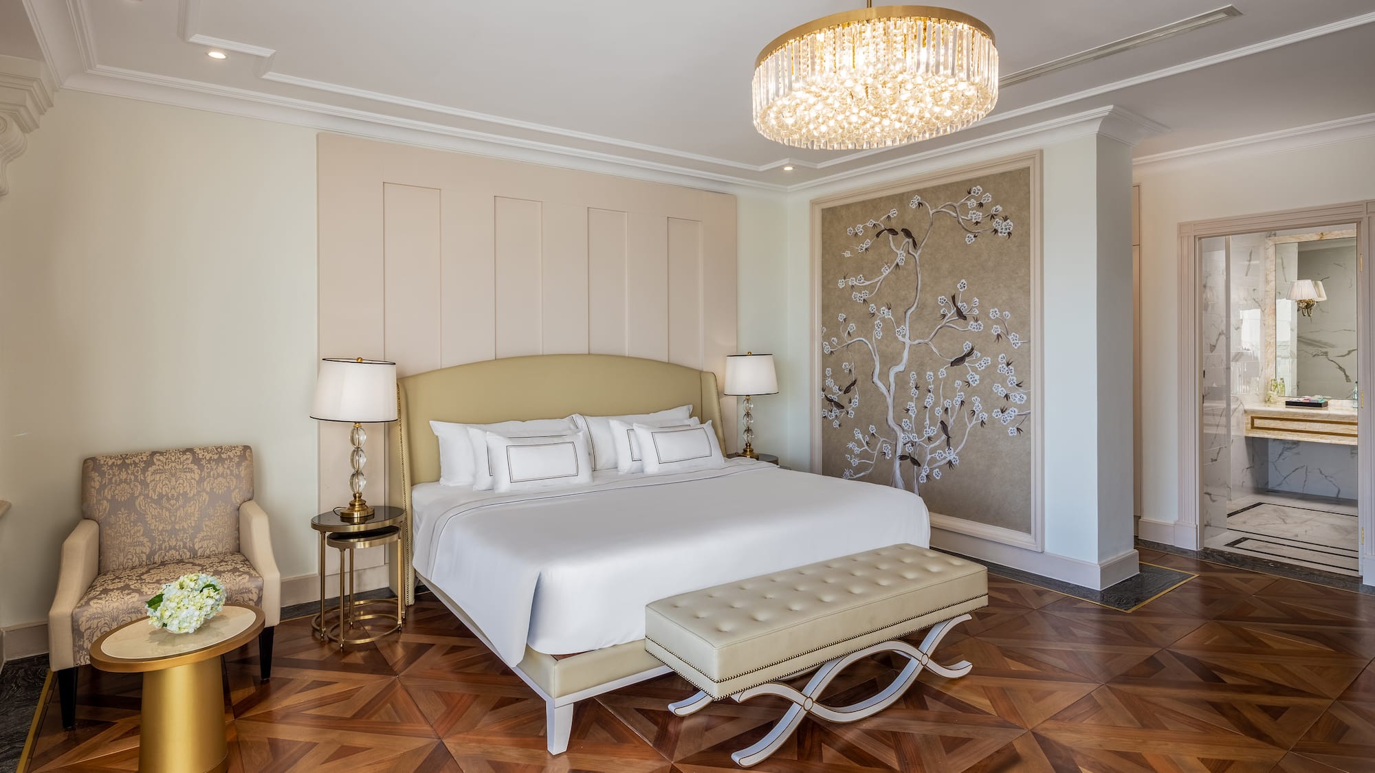 a bedroom with a bed and a chandelier