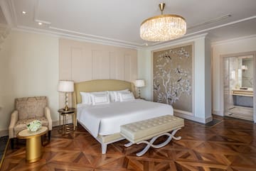 a bedroom with a bed and a chandelier