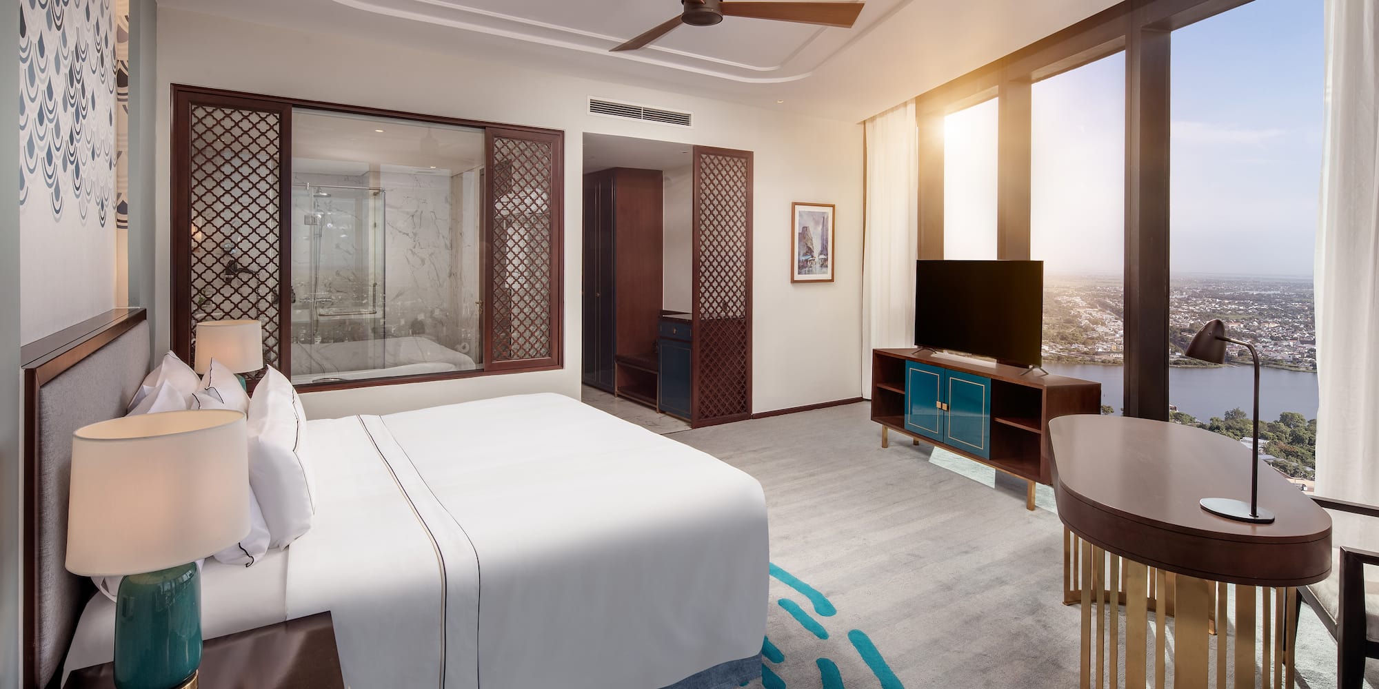 a room with a bed and a television