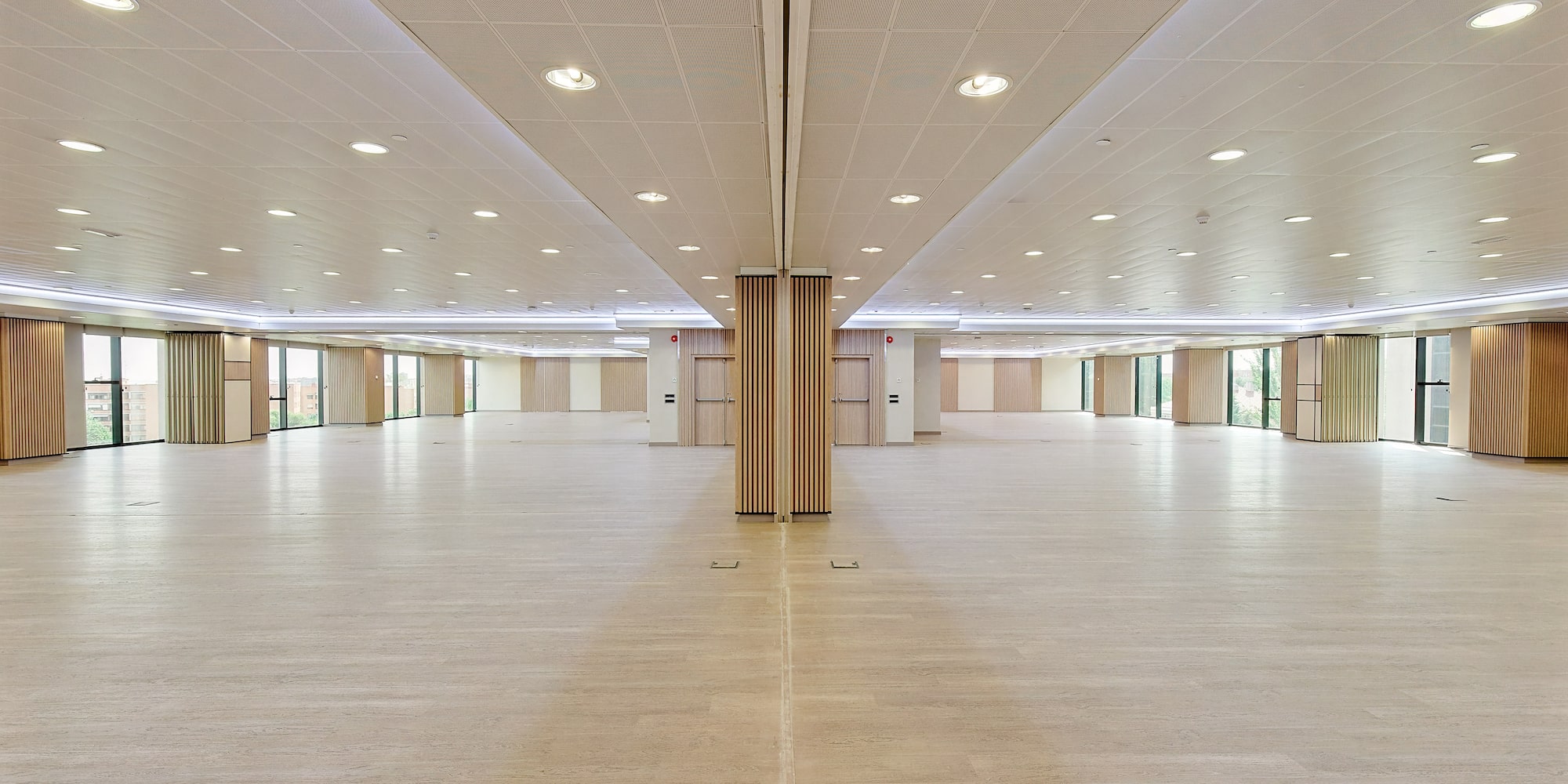 a large room with a wood floor and ceiling