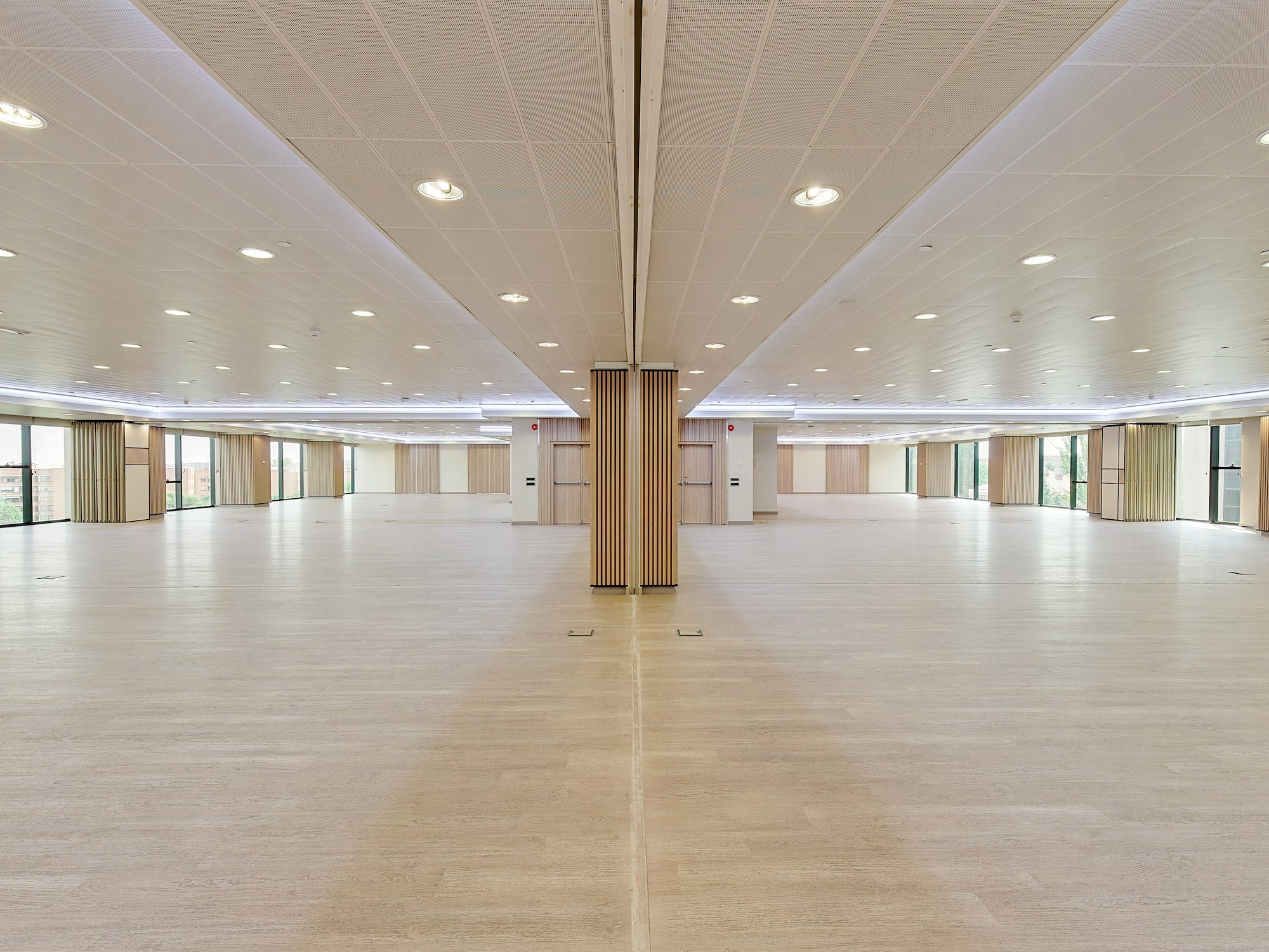 a large room with a wood floor and ceiling