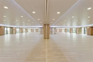 a large room with a wood floor and ceiling