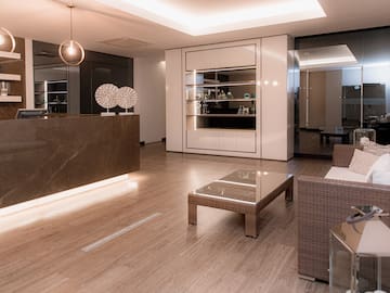 a room with a reception desk and chairs