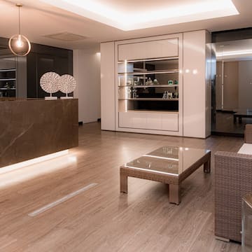 a room with a reception desk and chairs