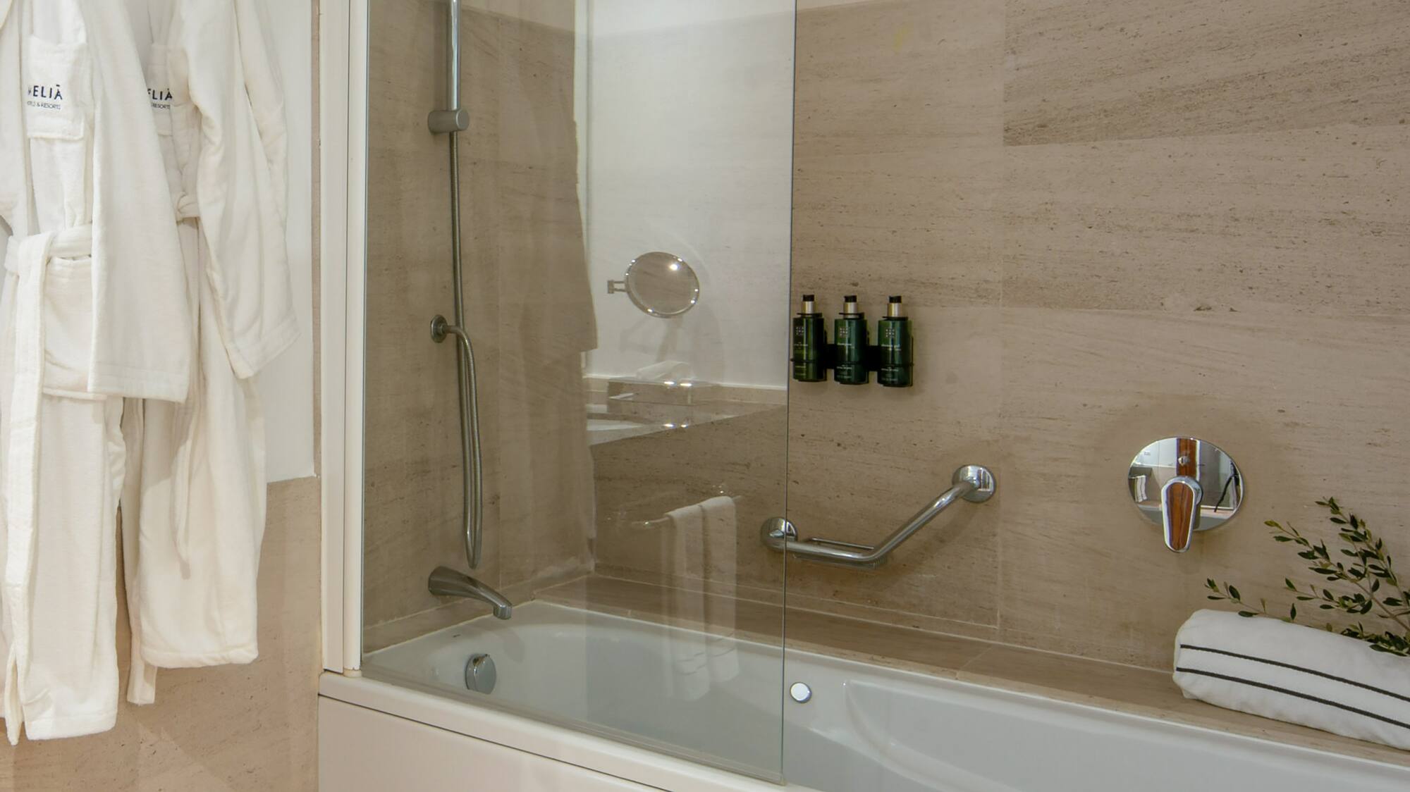 a bathtub and bathrobe in a bathroom