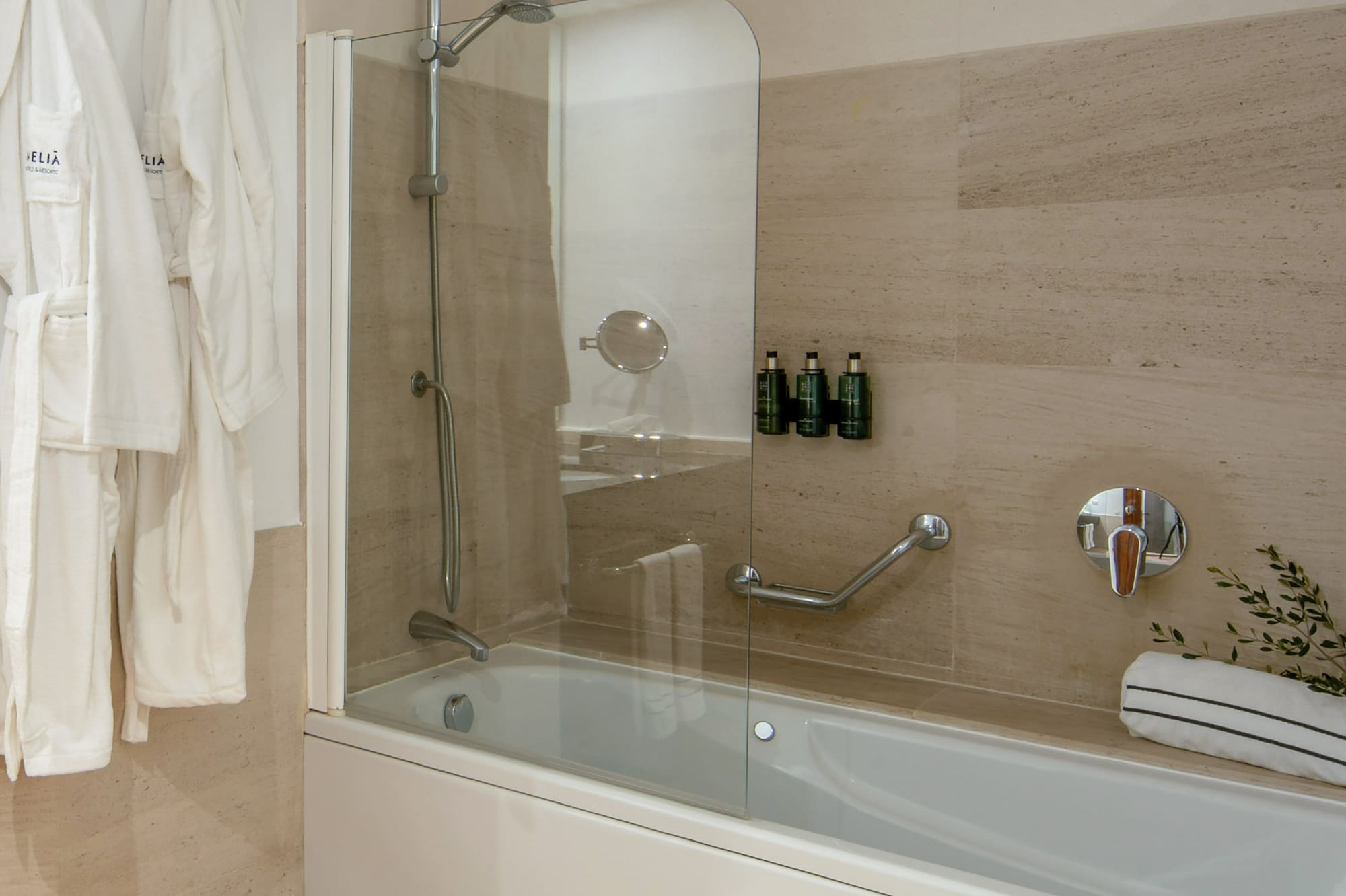 a bathtub and bathrobe in a bathroom