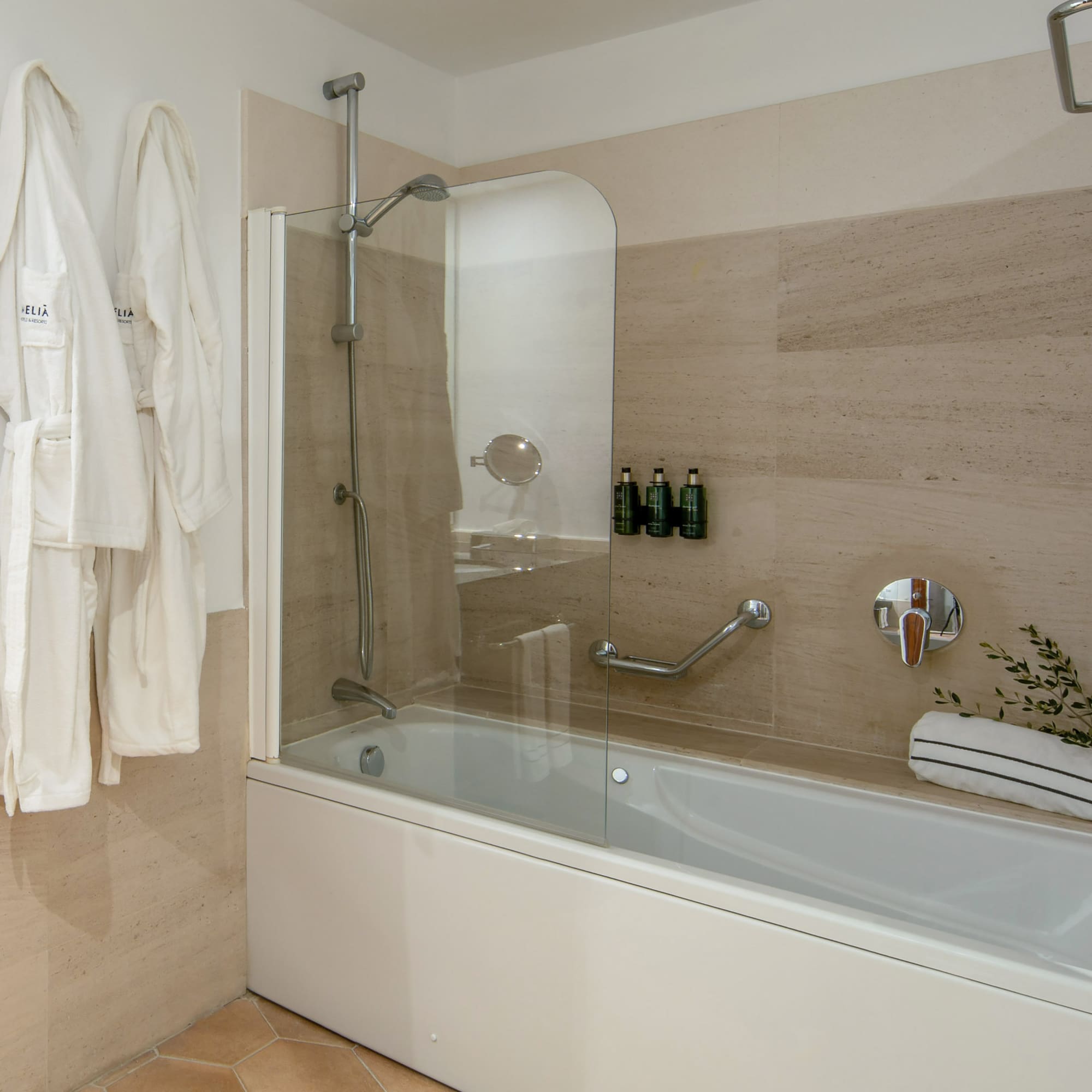 a bathtub and bathrobe in a bathroom