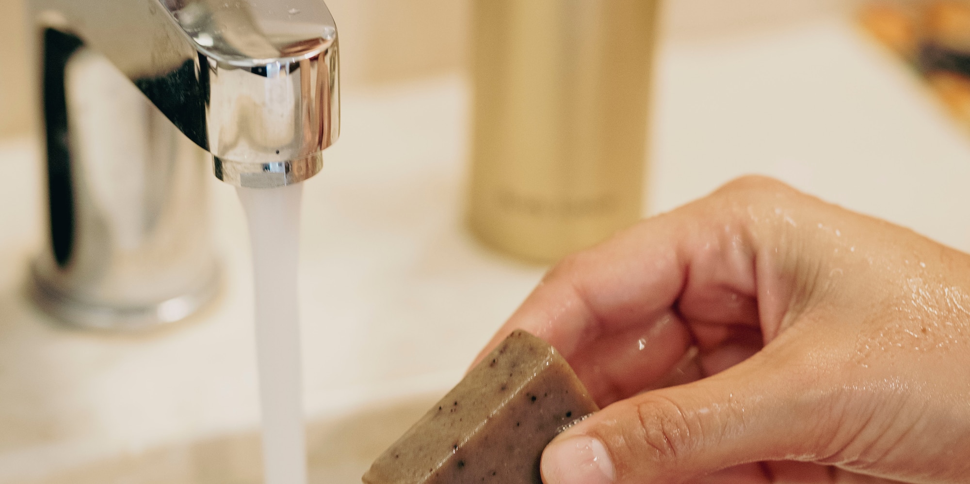 a person washing hands under running water