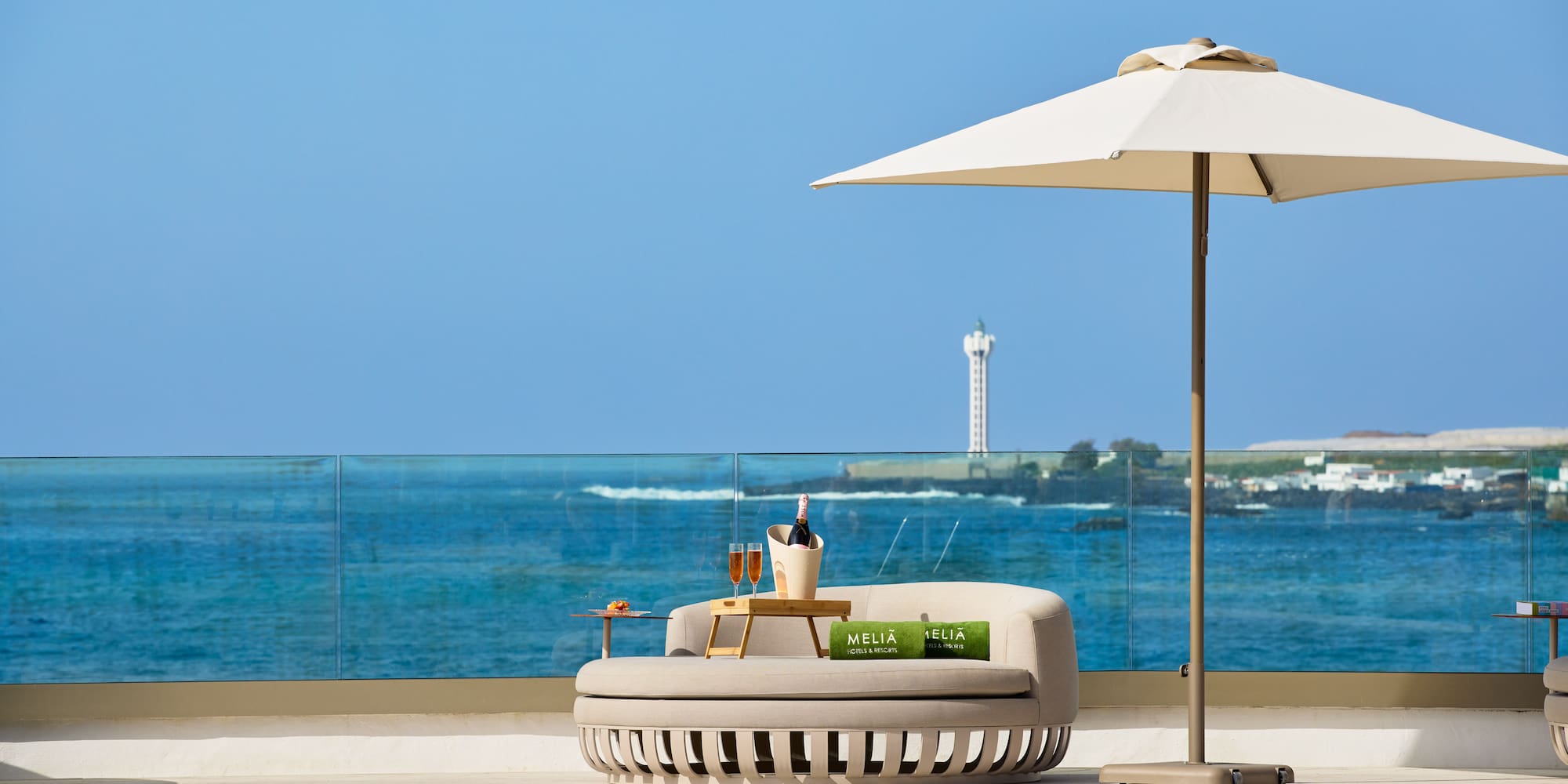 a pool with a lounge chair and umbrella