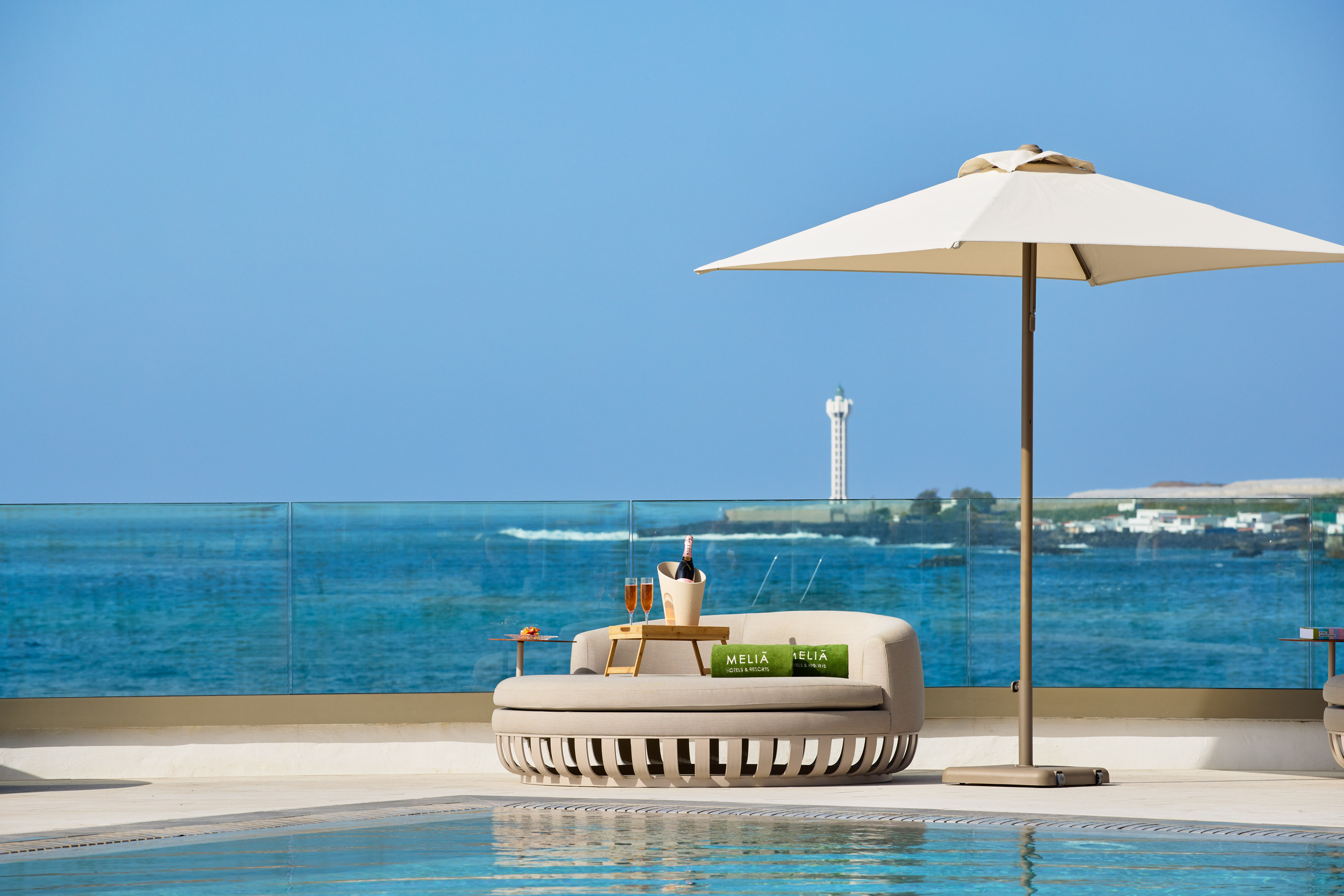 Meliã luxury hotel poolside daybed, champagne, and ocean view.